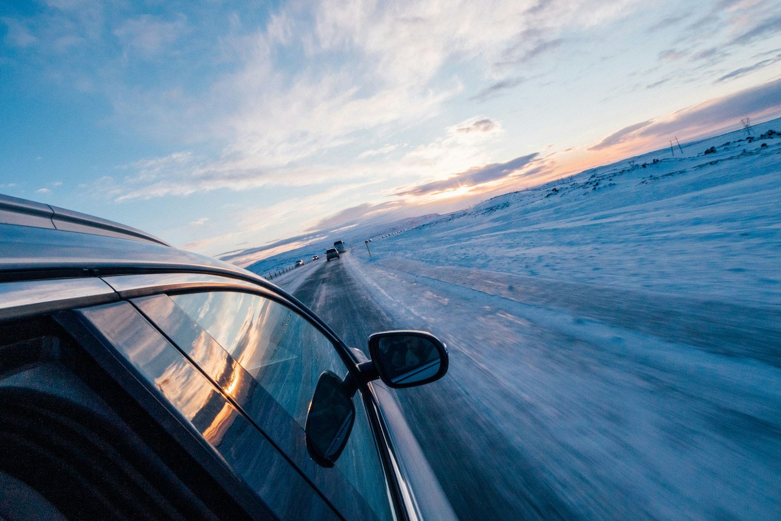 Rental car driving down a snowy road in Iceland