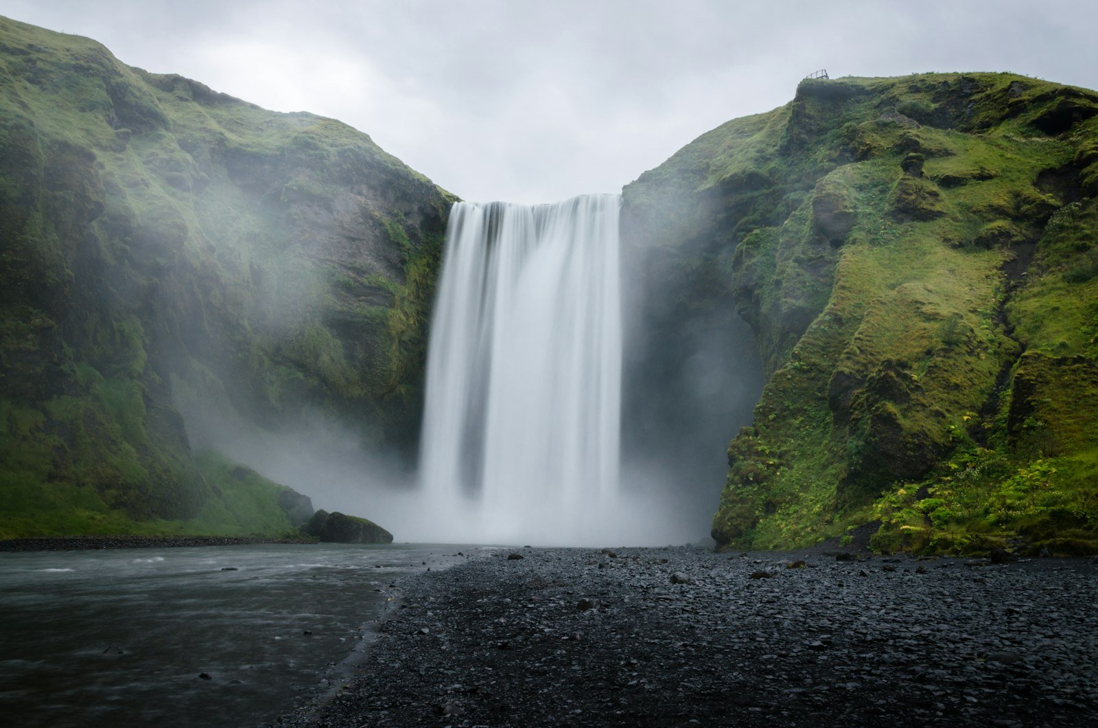 Waterfall on a green mountainside on Iceland's south coast