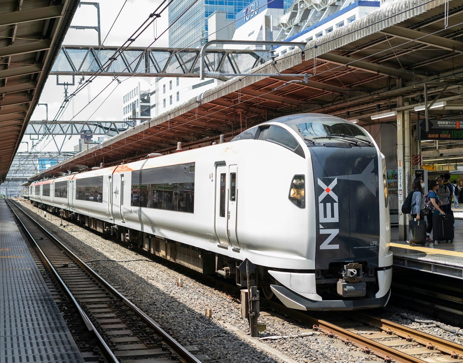 White express train pulling into a station in Japan
