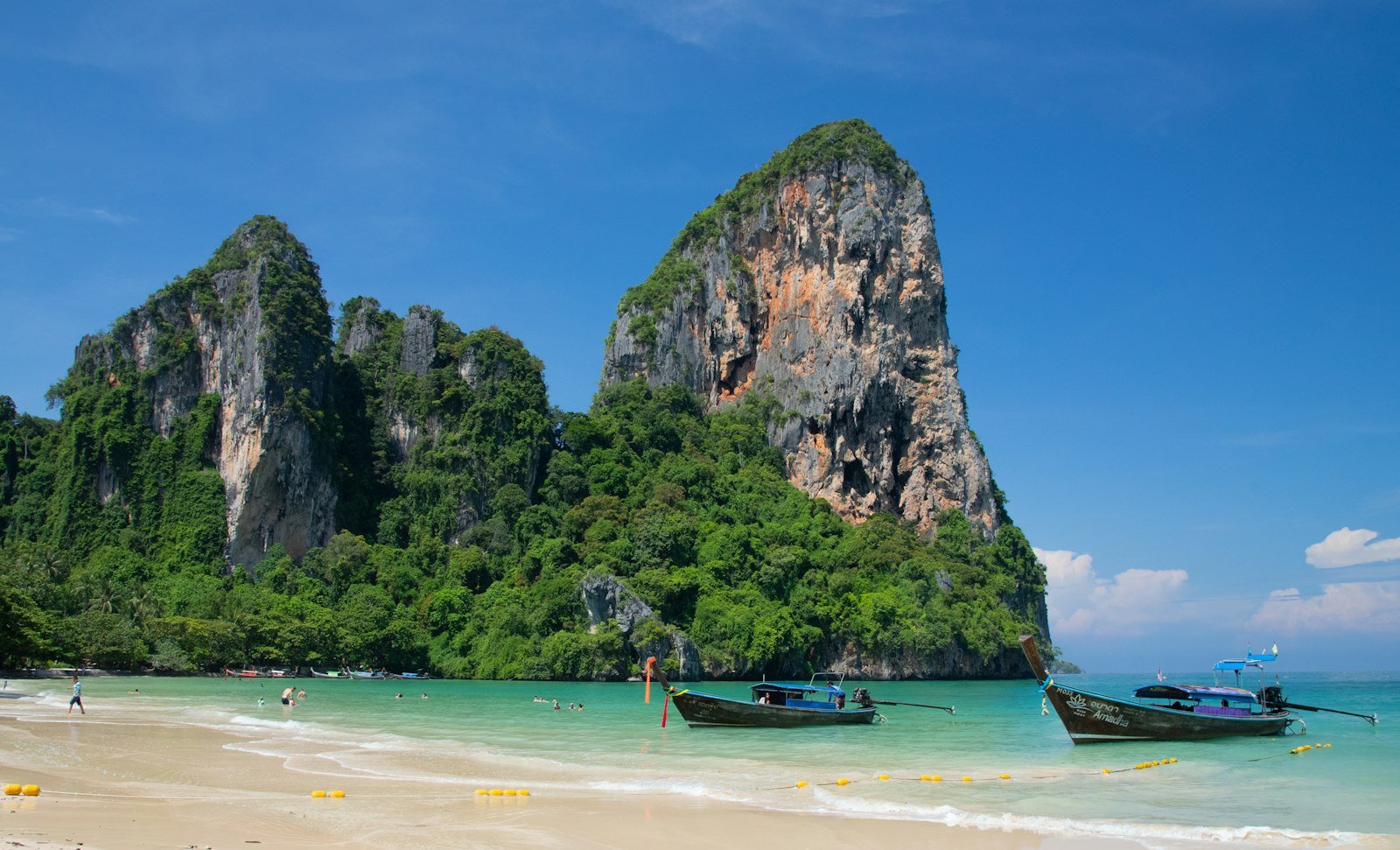 Longtail boats lined up on a beach in Krabi, Thailand
