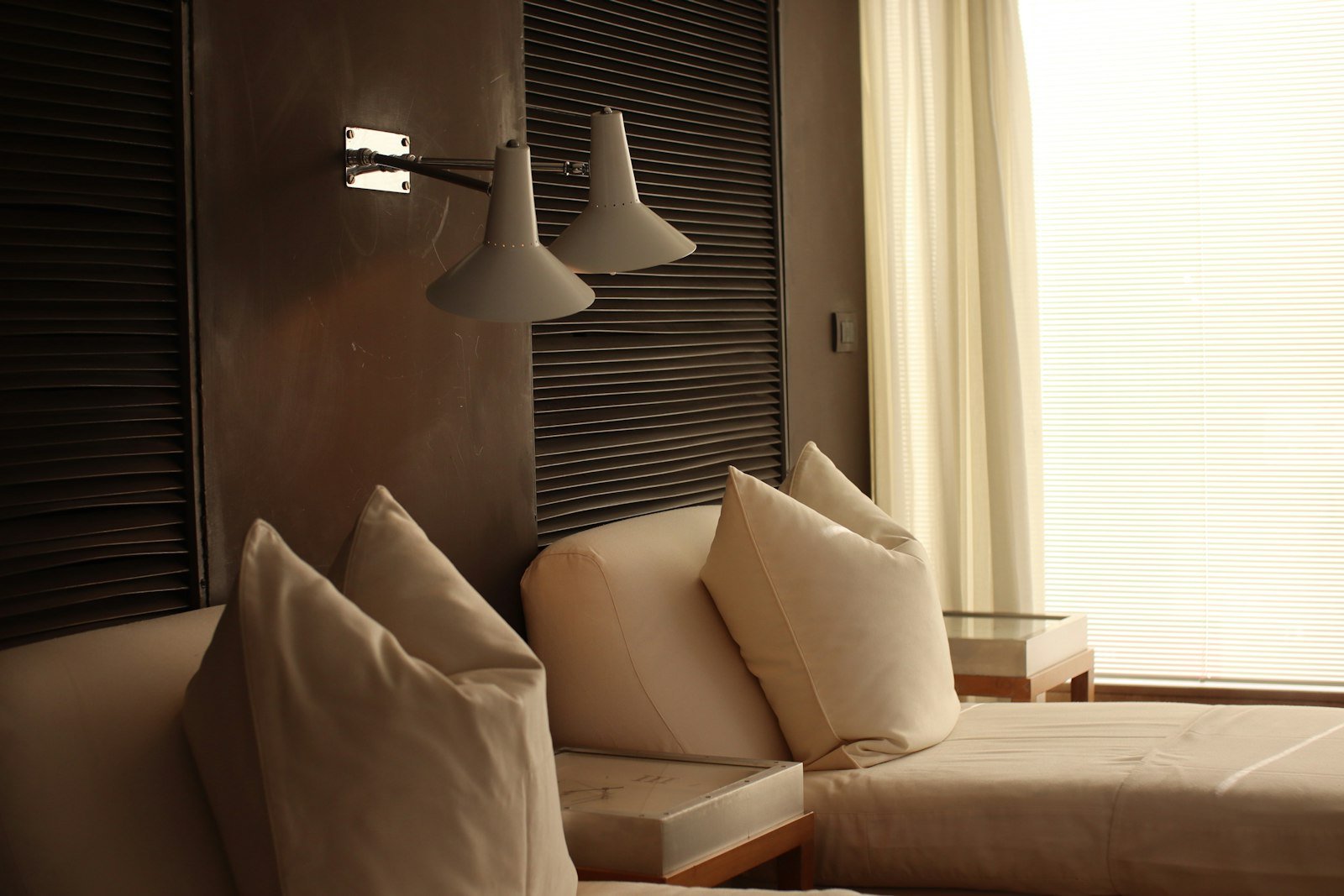 Neatly made bed in a boutique hotel room in Rome