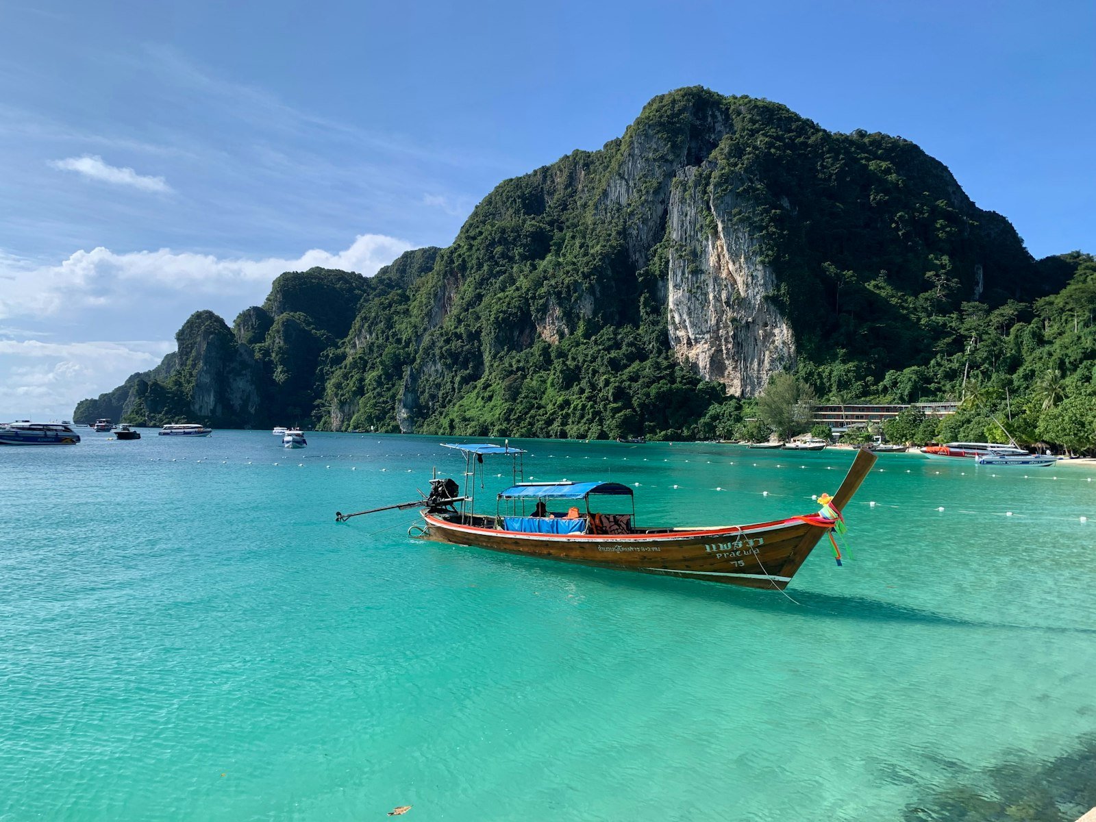 Traditional longtail boat on turquoise water in Thailand